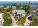 Beautiful aerial of the estate showcasing a waterfront neighborhood with mature palm trees and landscaping at 4935 W Bay Way Pl, Tampa, FL 33629