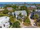 Gorgeous waterfront neighborhood aerial view showcasing a lovely estate with mature palm trees at 4935 W Bay Way Pl, Tampa, FL 33629