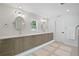 Well-lit bathroom featuring double vanity sinks, modern fixtures, and elegant lighting for a spa-like experience at 4935 W Bay Way Pl, Tampa, FL 33629