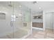 A modern bathroom features a spacious glass shower with a built-in bench and recessed shelving at 4935 W Bay Way Pl, Tampa, FL 33629