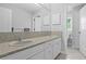 A bathroom boasts dual sinks, granite countertops, and modern fixtures at 4935 W Bay Way Pl, Tampa, FL 33629