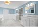 Bright bathroom with double vanity, marble floors, standing shower, soaking tub and ample space at 4935 W Bay Way Pl, Tampa, FL 33629