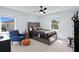 Nicely appointed bedroom with a comfortable chair, dark furniture, and lots of natural light at 4935 W Bay Way Pl, Tampa, FL 33629