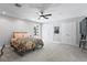 Serene bedroom featuring plush carpeting, a cozy bed, ample closet space, and natural lighting at 4935 W Bay Way Pl, Tampa, FL 33629