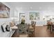 Sunlit dining area features a built-in bench, wooden table, and views of the outdoor area at 4935 W Bay Way Pl, Tampa, FL 33629