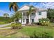 A beautiful two-story home featuring a classic facade with stately columns and walkway at 4935 W Bay Way Pl, Tampa, FL 33629