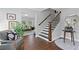 Charming foyer featuring hardwood floors, staircase, and views into the living room at 4935 W Bay Way Pl, Tampa, FL 33629