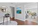 Inviting hallway with art, hardwood floors, and an archway leading to the living room at 4935 W Bay Way Pl, Tampa, FL 33629