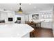 Open kitchen view featuring a large island, white cabinets, and stainless steel appliances, with adjacent dining area at 4935 W Bay Way Pl, Tampa, FL 33629