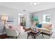 Bright living room with stylish decor, comfortable seating, and a view of the front entrance at 4935 W Bay Way Pl, Tampa, FL 33629