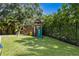 Backyard playground with a slide, swings and climbing area on a lush green lawn at 4935 W Bay Way Pl, Tampa, FL 33629
