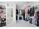 A spacious walk-in closet is fully organized with custom shelving and ample storage at 4935 W Bay Way Pl, Tampa, FL 33629