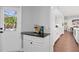 Chic wet bar area with sleek countertops, and access to the outdoor pool at 4935 W Bay Way Pl, Tampa, FL 33629