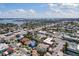 Wide aerial view of a coastal town with residential houses and commercial buildings under a bright sky at 506 71St Ave # 7, St Pete Beach, FL 33706