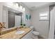 Bathroom featuring a large vanity, granite countertops, and tile surround tub at 506 71St Ave # 7, St Pete Beach, FL 33706