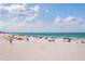 Beautiful beach view with calm water, perfect for swimming and relaxation at 506 71St Ave # 7, St Pete Beach, FL 33706
