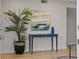 Inviting entryway with stylish console table, artwork, and decorative plant for a welcoming ambiance at 506 71St Ave # 7, St Pete Beach, FL 33706