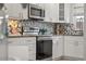 Updated kitchen with sleek stainless steel appliances, granite countertops, and stylish backsplash at 506 71St Ave # 7, St Pete Beach, FL 33706