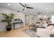 Bright living room featuring modern decor, wood floors, and an open layout leading to the kitchen at 506 71St Ave # 7, St Pete Beach, FL 33706