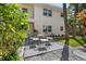 Spacious outdoor patio area with wrought iron furniture and lush landscaping at 506 71St Ave # 7, St Pete Beach, FL 33706