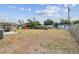 A large backyard features a patio area and wooden fence, offering ample space for outdoor enjoyment at 5121 Flamingo N Dr, St Petersburg, FL 33714