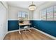 Bright bedroom with a study desk, chair, and a modern light fixture at 5121 Flamingo N Dr, St Petersburg, FL 33714