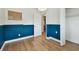 Bedroom with hardwood floors, blue accent wall and closet at 5121 Flamingo N Dr, St Petersburg, FL 33714
