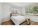 Cozy bedroom with natural light, hardwood floors, and a comfortable bed with soft linens at 5121 Flamingo N Dr, St Petersburg, FL 33714