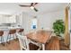 Bright dining area featuring a farmhouse-style table, bench seating, and view to the kitchen with breakfast bar at 5121 Flamingo N Dr, St Petersburg, FL 33714