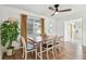 Dining room featuring a wood table, seating, window with curtains, and a modern ceiling fan at 5121 Flamingo N Dr, St Petersburg, FL 33714