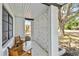 Inviting front porch with wooden chairs and table, decorative cinder blocks, and a view of the outdoors at 5121 Flamingo N Dr, St Petersburg, FL 33714