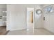 Bright hallway featuring a decorative mirror and views into the living space with a window at 5121 Flamingo N Dr, St Petersburg, FL 33714