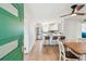 Open-concept kitchen featuring modern white cabinets, stainless steel appliances, and a cozy dining area at 5121 Flamingo N Dr, St Petersburg, FL 33714