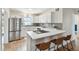 Updated kitchen with white cabinetry, stainless steel refrigerator, and bar seating at 5121 Flamingo N Dr, St Petersburg, FL 33714