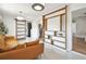 Stylish living room with modern furnishings, an open shelving unit, and access to the laundry room at 5121 Flamingo N Dr, St Petersburg, FL 33714