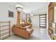 Bright living room featuring a comfortable sofa, large window, and access to a laundry room with sliding door at 5121 Flamingo N Dr, St Petersburg, FL 33714