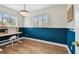Office space with two-tone walls, natural light, hardwood floors and a modern desk at 5121 Flamingo N Dr, St Petersburg, FL 33714