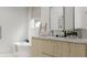 Modern bathroom features a soaking tub, dual sink vanity, and a bright window view at 5406 N Pershing Pl, Tampa, FL 33603