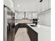 Modern kitchen featuring stainless steel appliances, dark wood cabinets and white countertops at 5406 N Pershing Pl, Tampa, FL 33603