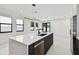 Modern kitchen with an island, stainless steel appliances and white countertops, perfect for cooking at 5406 N Pershing Pl, Tampa, FL 33603