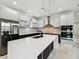 Contemporary kitchen design featuring sleek cabinetry, stainless steel refrigerator, and expansive center island at 5406 N Pershing Pl, Tampa, FL 33603