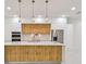 Beautiful kitchen boasts stainless steel appliances, a marble countertop, and a wood-paneled island at 5406 N Pershing Pl, Tampa, FL 33603