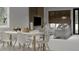 Contemporary dining and living room with modern furniture and a large window with natural light at 5406 N Pershing Pl, Tampa, FL 33603