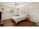 Bright bedroom with wood floors featuring two windows and neutral tones at 5636 Baywater Dr # 5636, Tampa, FL 33615