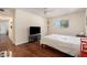Bedroom featuring wood floors and a tv at 5636 Baywater Dr # 5636, Tampa, FL 33615