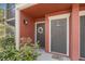Close-up of a condo doorway with muted terra cotta exterior and welcoming floral wreath at 5636 Baywater Dr # 5636, Tampa, FL 33615