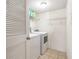 Functional laundry room with a washer, dryer, and shelving for storage at 5636 Baywater Dr # 5636, Tampa, FL 33615