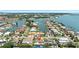 Scenic aerial shot of a waterfront neighborhood surrounded by canals and stunning bay views in the distance at 6129 Leeland S St, St Petersburg, FL 33715