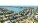Aerial view of a neighborhood with homes, lush trees, and waterfront views at 6129 Leeland S St, St Petersburg, FL 33715