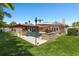 Spacious backyard offering a sparkling pool, ample seating areas, and lush green grass for outdoor enjoyment at 6129 Leeland S St, St Petersburg, FL 33715